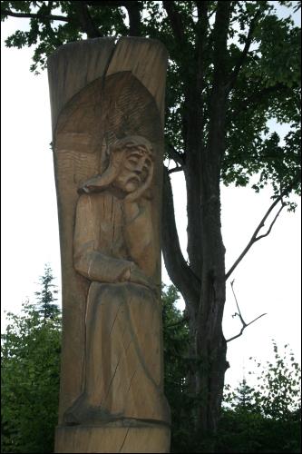  - Catholic church of the Holy Trinity. The wooden figure of Christ in front of the church